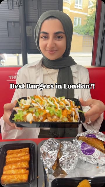 A food review video featuring a creator trying various burgers, loaded fries, and sides at The Burger Firm. The video highlights the menu items, including the 'pandemic burger' and 'mac burger', while emphasizing the portion sizes and sharing options.
