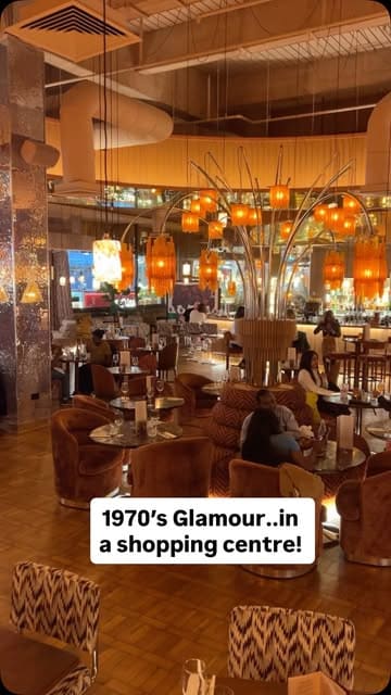A venue tour of the new Cosy Club location at Westfield Stratford, highlighting the 1970s-inspired decor, various seating areas, and the menu offerings.