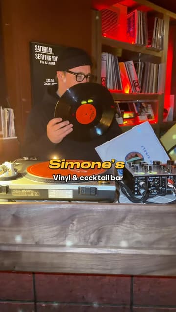 A stylish promotional video for Simone's, a vinyl and cocktail bar in Liverpool. The video features a montage of the venue's interior, focusing on the vinyl record player, the bar area, and a selection of signature cocktails, all set to a rhythmic soundtrack.
