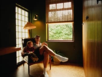 A family spends a weekend at Villa Vista Cotswolds, featuring scenes of the father and his two young children playing, eating, and relaxing in the property's indoor and outdoor spaces.