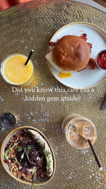 The video features a creator visiting The Den & Golf Box in Bath, showcasing the cafe's brunch offerings like a burger and granola bowl, followed by the indoor golf simulator experience.