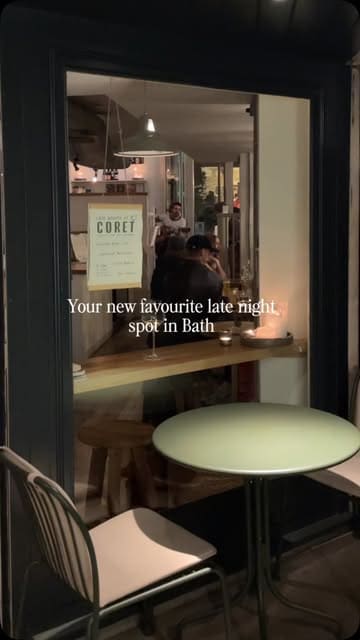 A short, atmospheric montage showcasing a venue in Bath that transitions from a coffee shop during the day to a cozy bar at night, highlighting live music, happy hour, and wine offerings.