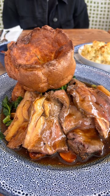 A montage video showcasing a visit to Coppa Club at The Swan at Streatley, featuring the interior, the waterside setting, and a selection of Sunday roast dishes and desserts.