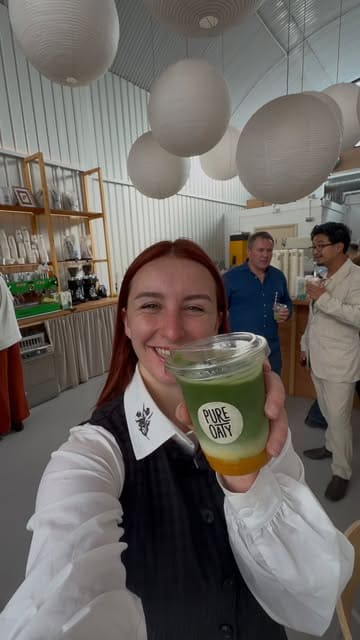 A vlogger attends a launch event for a new coconut oat drink, showcasing the product packaging, the venue, and a three-course breakfast menu featuring the oat milk in various dishes and drinks.