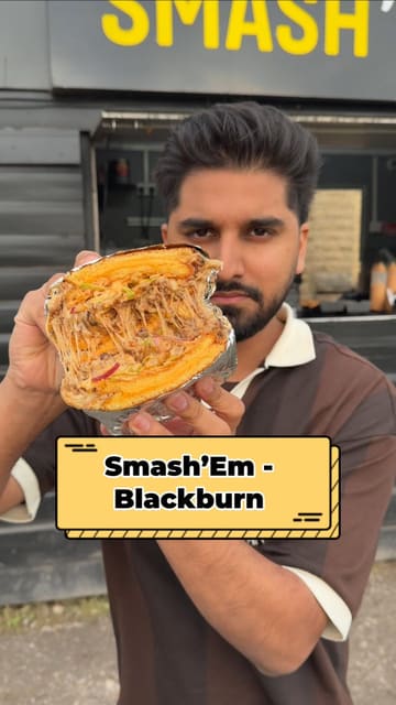 A short, punchy review of a new smash burger drive-thru in Blackburn. The video follows the creator as they order, receive, and eat the food, showcasing the menu items like smash burgers and loaded fries, as well as the convenience of the drive-thru service.