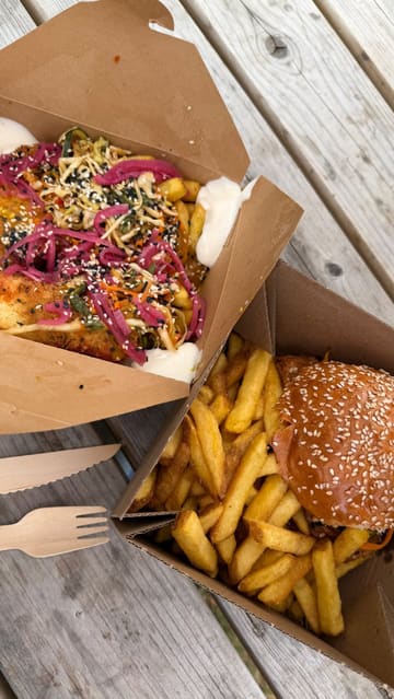 A short vlog-style video visiting Daisy's Milk Shed in Attleborough, Norfolk, showcasing the outdoor venue, the Dirty Fryer Boys food truck, and Heavenly Crumbles dessert truck. The video features shots of the food, the setting, and the creators enjoying their meal.