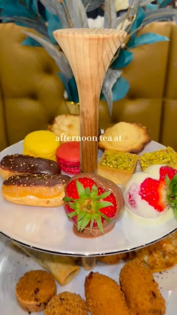 A short, aesthetic montage showcasing an afternoon tea service at Haute Dolci, featuring close-ups of the tiered stand, tea pouring, and interior decor.