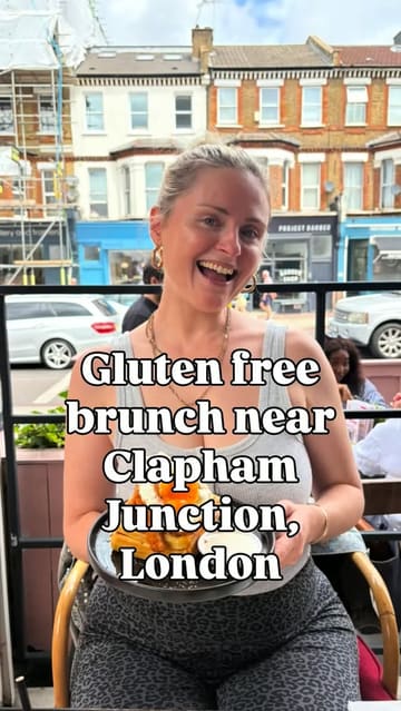 A creator reviews a brunch spot in Clapham Junction, specifically highlighting their extensive gluten-free menu options, separate fryers, and overall coeliac-friendly practices. The video features shots of the exterior, the menu, and the fried chicken and waffles dish.