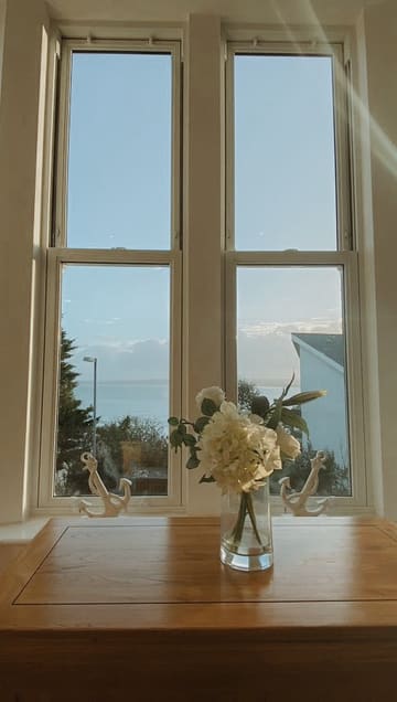 A promotional video showcasing the interior of Porthminster View in St. Ives, including the living area, bedroom, and swimming pool, ending with a sunset beach shot.