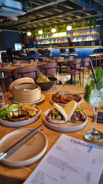 A video showcasing a variety of dim sum dishes and cocktails at Eightfold in Bristol, featuring close-ups of the food and the creator trying the dishes.