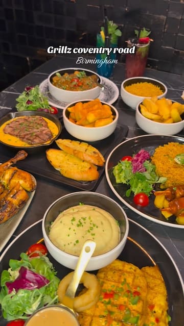 A montage-style video showcasing various dishes and drinks from Grillz in Birmingham, including lamb chops, steak, chicken, and desserts. The video features slow-motion shots of food being presented and poured, set to music with text overlays identifying the venue.