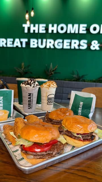 A vlog-style promotional video for Urban Fresh Burgers in Barnsley, showing the journey to the venue, the interior, and a variety of food items including burgers, fries, onion rings, and milkshakes.