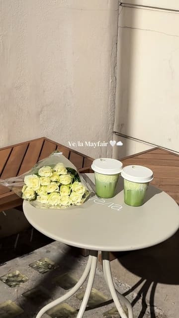 A short, aesthetic montage showcasing the interior and menu offerings of Ve/la, a specialty coffee and matcha cafe in Mayfair, London. The video features shots of the cafe's exterior, minimalist wood-panelled interior, coffee equipment, and matcha drinks.