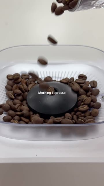 A short, aesthetic product demonstration video showcasing the Philips Baristina coffee machine, focusing on the process of making an espresso from bean to cup.