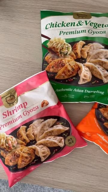 A short, edited video demonstrating a 'sauce challenge' using frozen gyoza. The creator prepares the dumplings in a pan and then tests them with three different sauce combinations, including chilli oil, soy sauce, and sesame sauce.