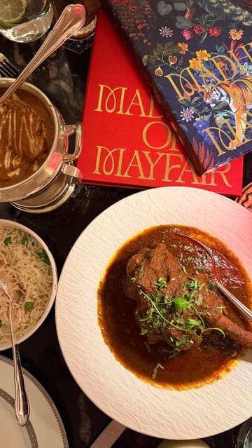 A review of a dining experience at Madhu's of Mayfair, showcasing the interior, cocktails, and a variety of Indian dishes including butter chicken chops, palak chaat, and a mango dessert.