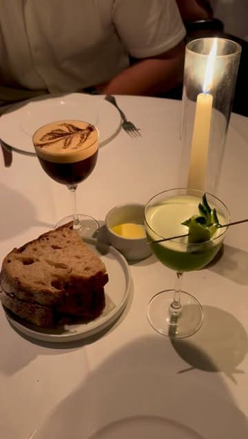 A short, aesthetic montage showcasing a dinner experience at Mister Nice in Mayfair, featuring cocktails, starters like burrata and cod roe, mains including vodka pasta and a Wagyu burger, and a New York cheesecake.