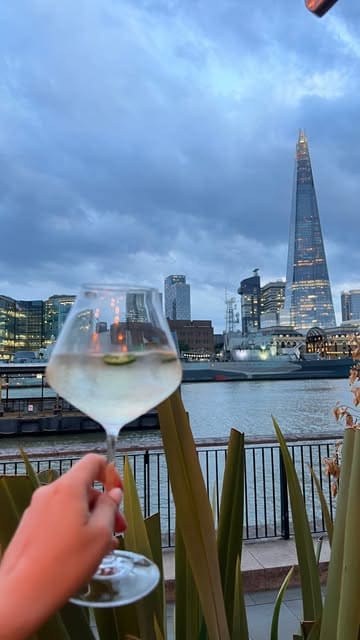 A short, aesthetic montage showcasing a dining experience at Coppa Club Tower Bridge, highlighting the riverside views, cocktails, and various dishes like tuna and burrata.