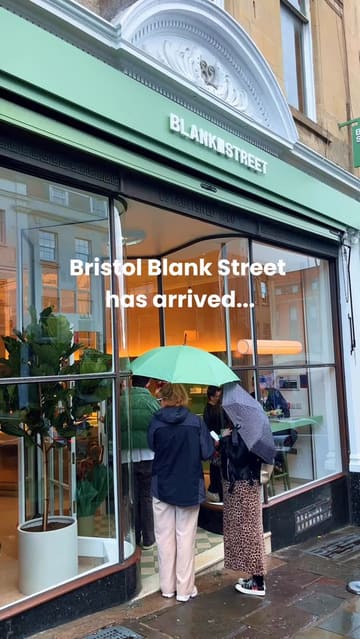A promotional video for the opening of a new Blank Street coffee shop in Bristol. The video features shots of the shop's interior, staff preparing drinks, and a close-up of a flight of various matcha beverages being poured.