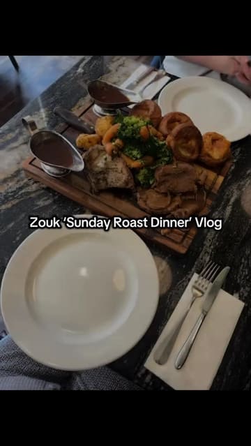 A vlog-style video documenting a visit to Zouk for a Sunday roast, featuring shots of the exterior, interior, mocktails with dry ice, starters, a large roast platter, and desserts.