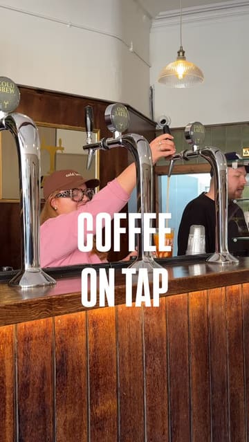 A vlog-style reel introducing a new coffee shop in Glasgow called 'Taps by Eight,' which features a unique coffee-on-tap system. The video shows the creators visiting the venue, demonstrating the pouring process, and enjoying their drinks.