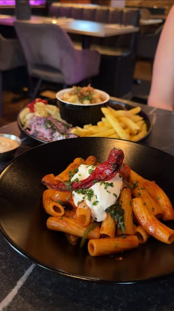 A review-style video showcasing a variety of dishes at Notch in Durham, including BBQ, Italian, and desserts. The creator presents the food clearly with voiceover commentary.