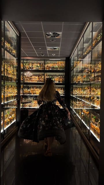A short, slow-motion clip featuring a creator walking through the Diageo Claive Vidiz Collection at The Scotch Whisky Experience in Edinburgh, showcasing the extensive whisky display.