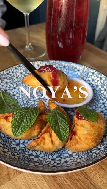 A short, polished reel showcasing a Vietnamese restaurant in Bath, featuring close-up shots of dishes like crispy pork dumplings, chicken curry, and beef brisket soup, alongside glimpses of the restaurant's interior and outdoor seating area.