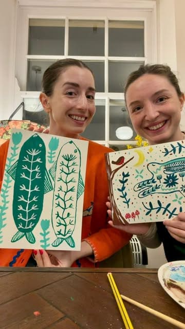 A vlog-style video showcasing a 'Painting and Pinot' workshop at April 11 in Durham. The video features two friends participating in the activity, enjoying wine and a cheese board, and highlighting the relaxed, creative atmosphere of the venue.