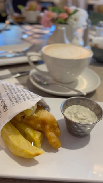 A vlog-style video showcasing a visit to Housing Units, a home decor store, where the creator and their stepdad enjoy an afternoon tea in the on-site restaurant.