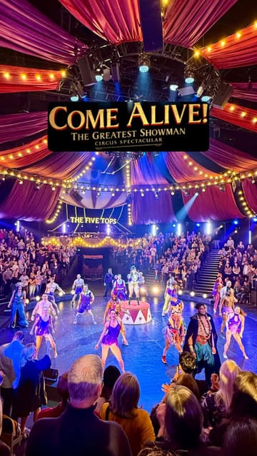 A high-energy, immersive vlog showcasing the 'Come Alive' Greatest Showman circus experience in London, highlighting the pre-show atmosphere, roaming performers, and main stage performances.