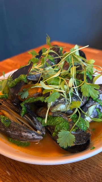 A review of Kelp in Glasgow, highlighting their sustainable Scottish seafood menu. The video features a variety of small plates, cocktails, and desserts, with a focus on the crab donut, scallops, and lamb shoulder.