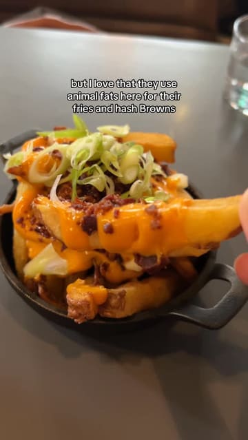 A first-person review of a brunch visit to Partick Duck Club in Glasgow, featuring close-ups of various dishes including a sausage breakfast sandwich, duck hash, fries, and a cinnamon bun dessert, along with a shot of the menu and the final bill.