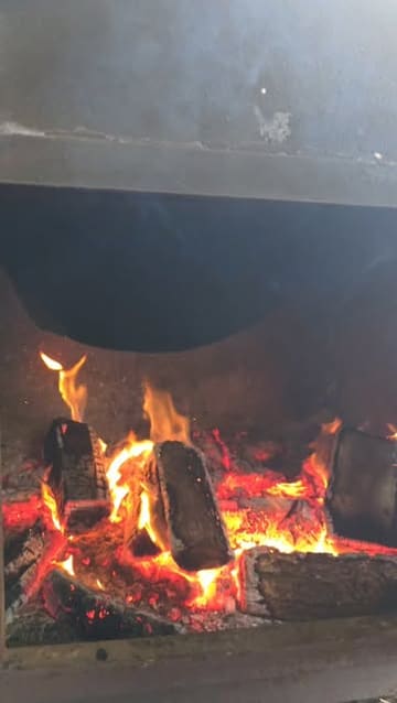 A short video showcasing a BBQ smoking class at a venue called Smoke in Carryduff. The footage focuses on the smoking process, showing various cuts of meat like ribs, chicken, and pork belly being prepared and cooked in a large smoker.