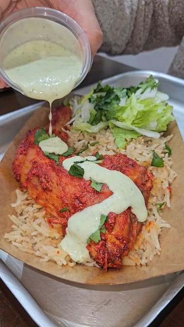 The video provides a tour of the menu at Aroma Cafe, highlighting their paratha rolls, various indulgent cookies, and a pistachio tiramisu latte. It uses a mix of close-up food shots and menu displays to entice viewers.