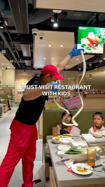 A vibrant reel showcasing a family visit to Haidilao Hot Pot, focusing on the interactive noodle dance performance and the DIY hot pot cooking experience at the table.