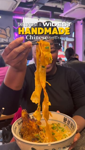A short, punchy review of Belt Noodles in London, featuring close-ups of their signature wide handmade noodles, grilled skewers, and other dishes. The video captures the busy, casual atmosphere of the restaurant.
