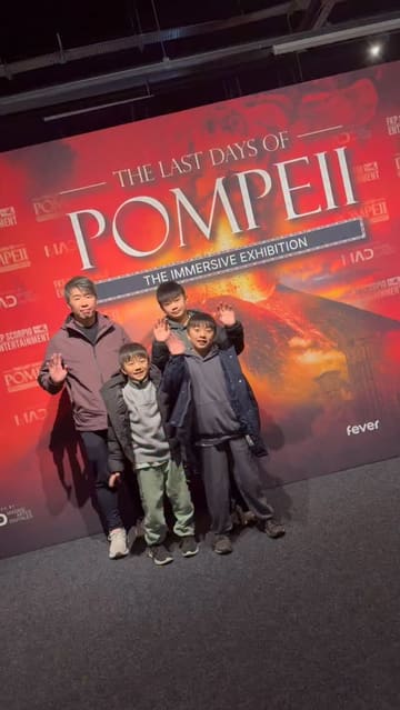 A family-focused vlog showcasing an immersive exhibition about Pompeii at ExCeL London, highlighting various interactive elements like VR, 360-degree projections, and AI photo booths.