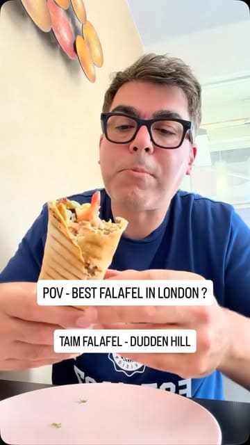 A creator visits a small, newly opened falafel shop in Dudden Hill, London, to support a local business. He interviews the owner, orders a falafel wrap and hummus, and provides an honest review of the food and the experience.