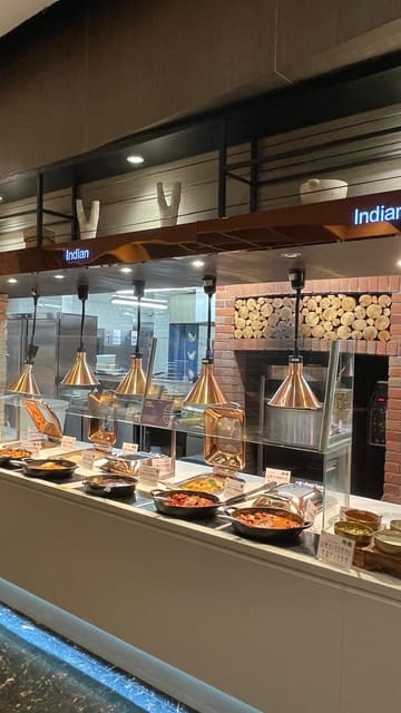 A montage of various dishes at an all-you-can-eat buffet restaurant, featuring sushi, teppanyaki, ribs, and desserts.