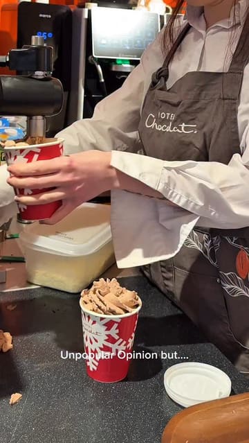 A short vlog-style video reviewing a visit to a Hotel Chocolat cafe, focusing on the hot chocolate experience. The creator shares their opinion on the drink while showing the cafe interior and the preparation process.