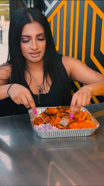 The video features a creator visiting Grill Avenue, showcasing the exterior of the venue and sampling various menu items including a chicken and rice box, a burger, and a milkshake.