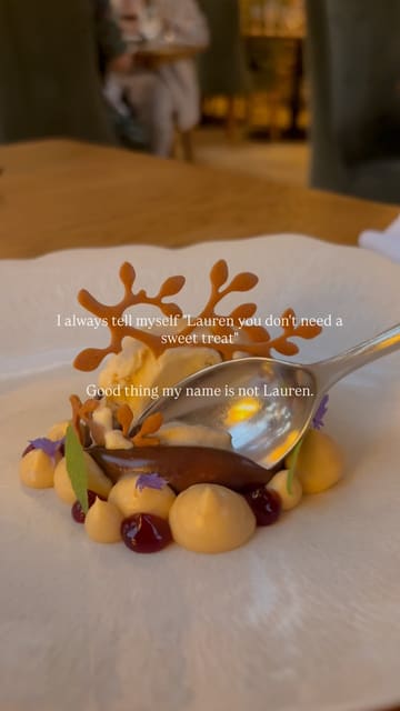 A single, slow-motion macro shot of a spoon taking a bite out of a plated chocolate dessert. The video features text overlay about enjoying a sweet treat.