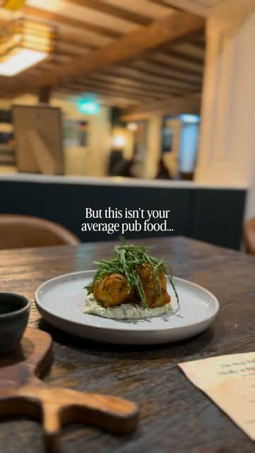 A montage video showcasing the interior and food offerings of The Stag, a gastropub in Norfolk. The video features shots of the pub's exterior, cozy interior, and various plated dishes, highlighting the elevated nature of the food.