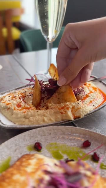 A montage showcasing the interior and new menu items at The Sultan, a Turkish and Mediterranean restaurant in Cardiff Bay. The video features close-ups of various dishes including flatbread, dips, halloumi, and a mixed grill platter, alongside shots of the restaurant's dining area.