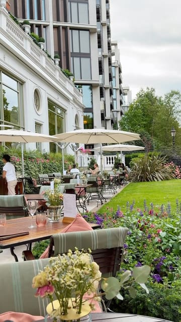 A visually appealing, polished showcase of the Secret Summer Garden at the Mandarin Oriental Hyde Park, highlighting the elegant outdoor setting, cheese board, and dessert selection.