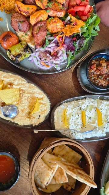 A family-focused review of Olive Lounge in Beverley, showcasing the restaurant's interior, the open charcoal grill, a variety of Turkish dishes including kebabs and desserts, and the overall dining experience.