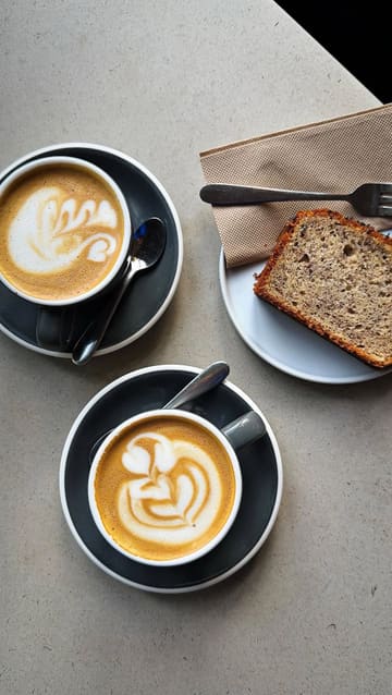 A montage-style video showcasing the interior, coffee, and baked goods of a cafe in Edinburgh. The video uses slow, steady shots to highlight the minimalist decor, the espresso machine, and the coffee service, creating a calm and inviting mood.