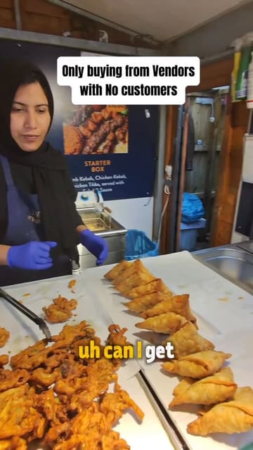 A short vlog-style video where the creator visits a street food stall in Manchester that has no customers, interacts with the vendor, and purchases food.