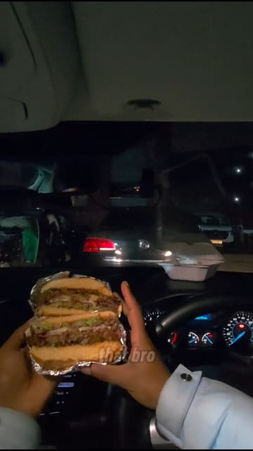 A creator visits a takeaway spot in Bolton called Mr Barbecue, orders a variety of items including a brisket burger, smash patties, and wings, and reviews them while eating in their car.